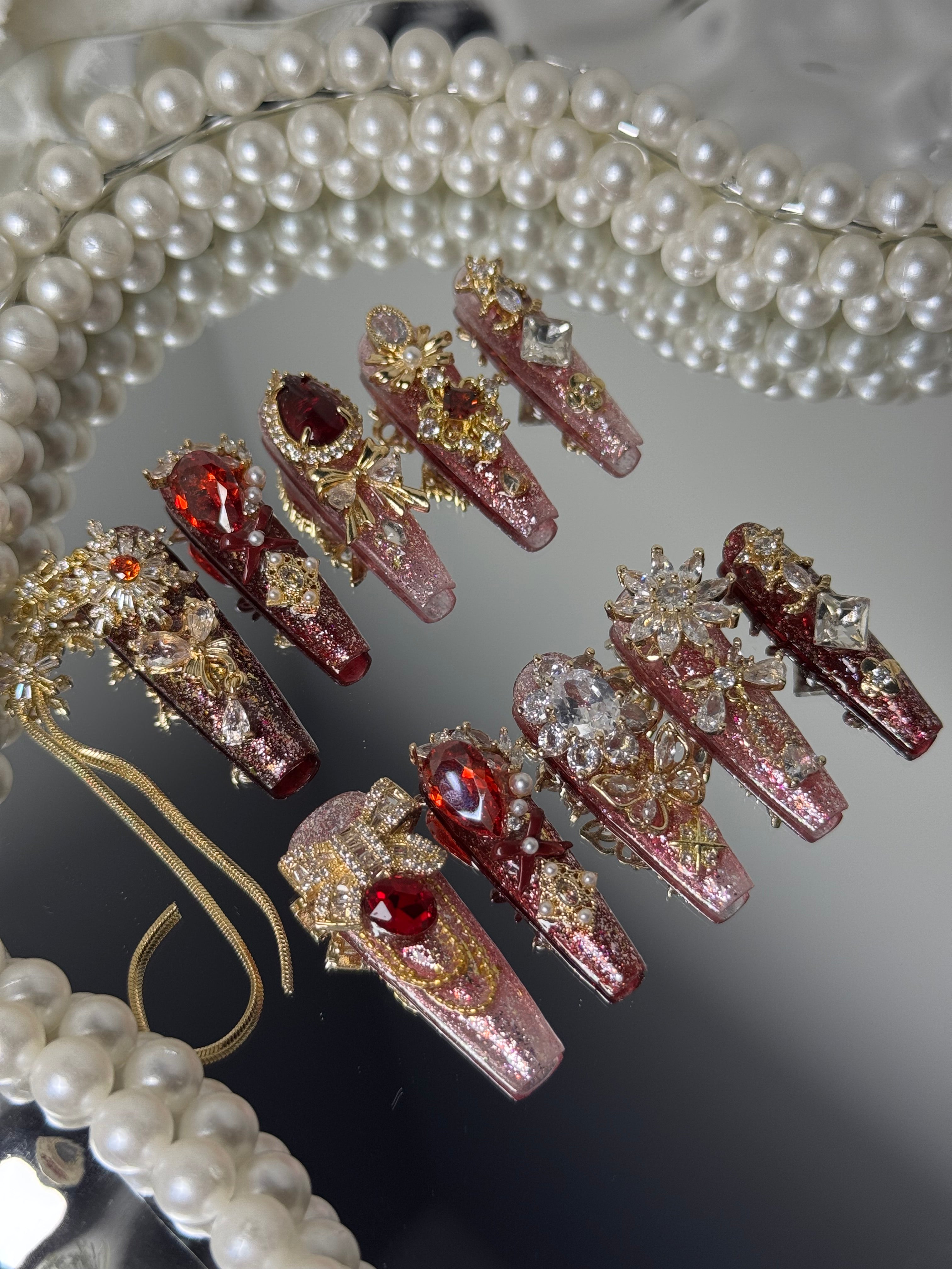 Close-up of Ruby Queen Nails – Elegant Press-On Nails with Gold and Diamonds