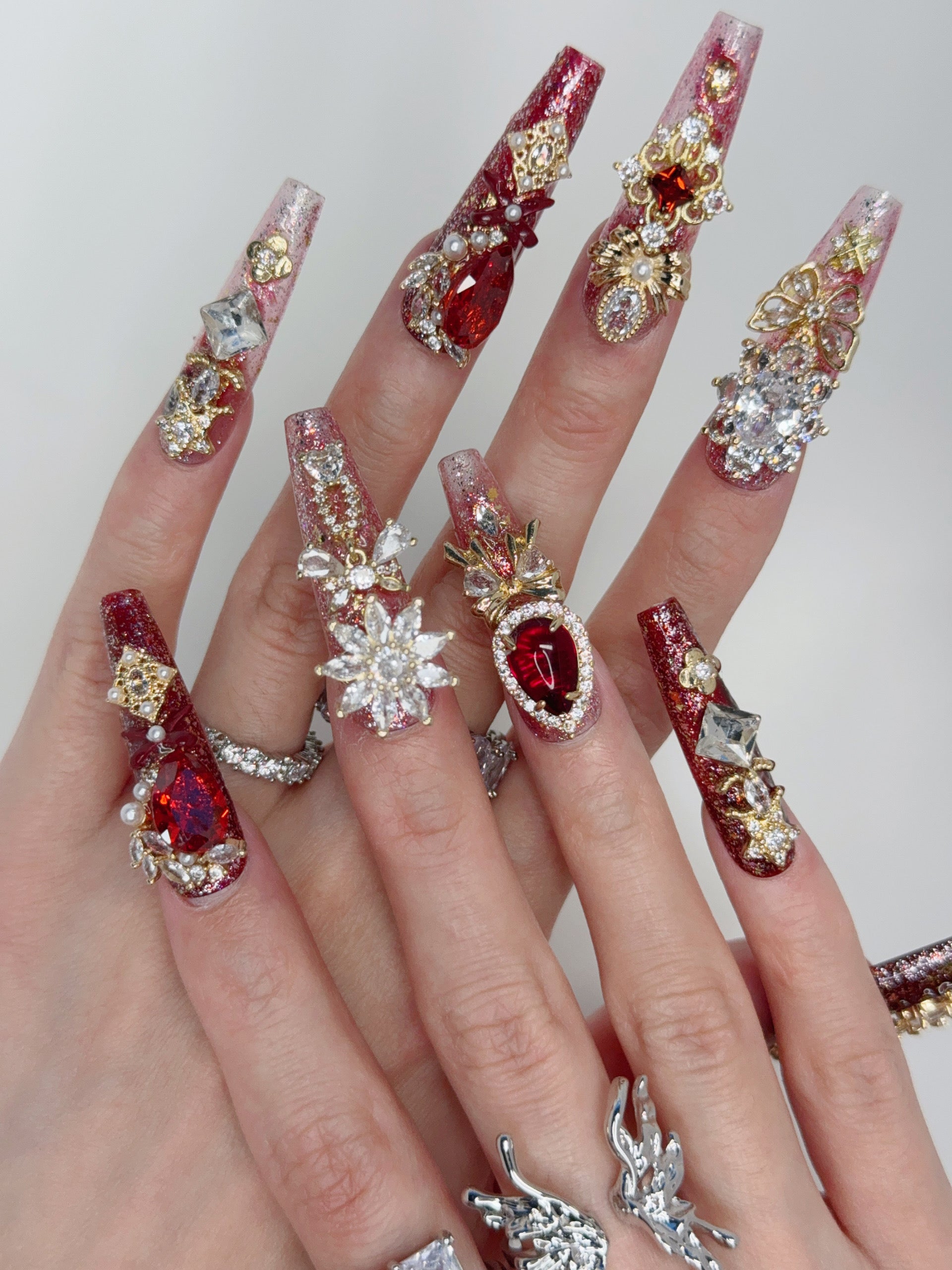 Close-up of Ruby Queen Nails – Elegant Press-On Nails with Gold and Diamonds
