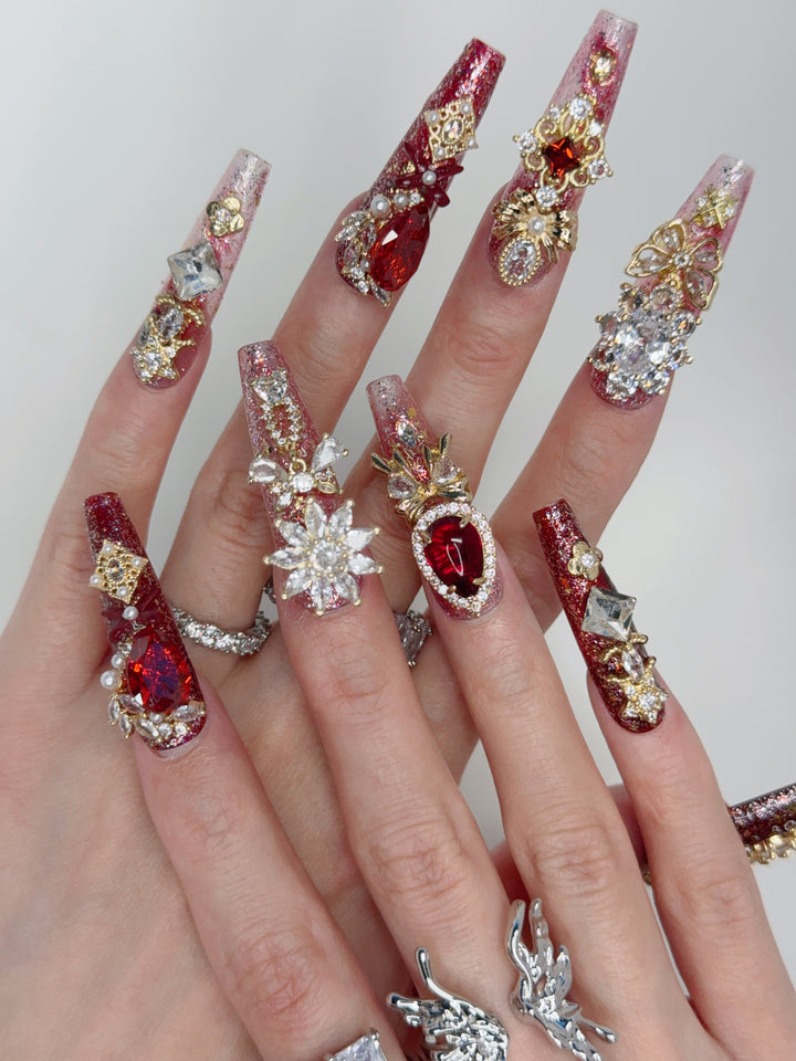Close-up of Ruby Queen Nails – Elegant Press-On Nails with Gold and Diamonds